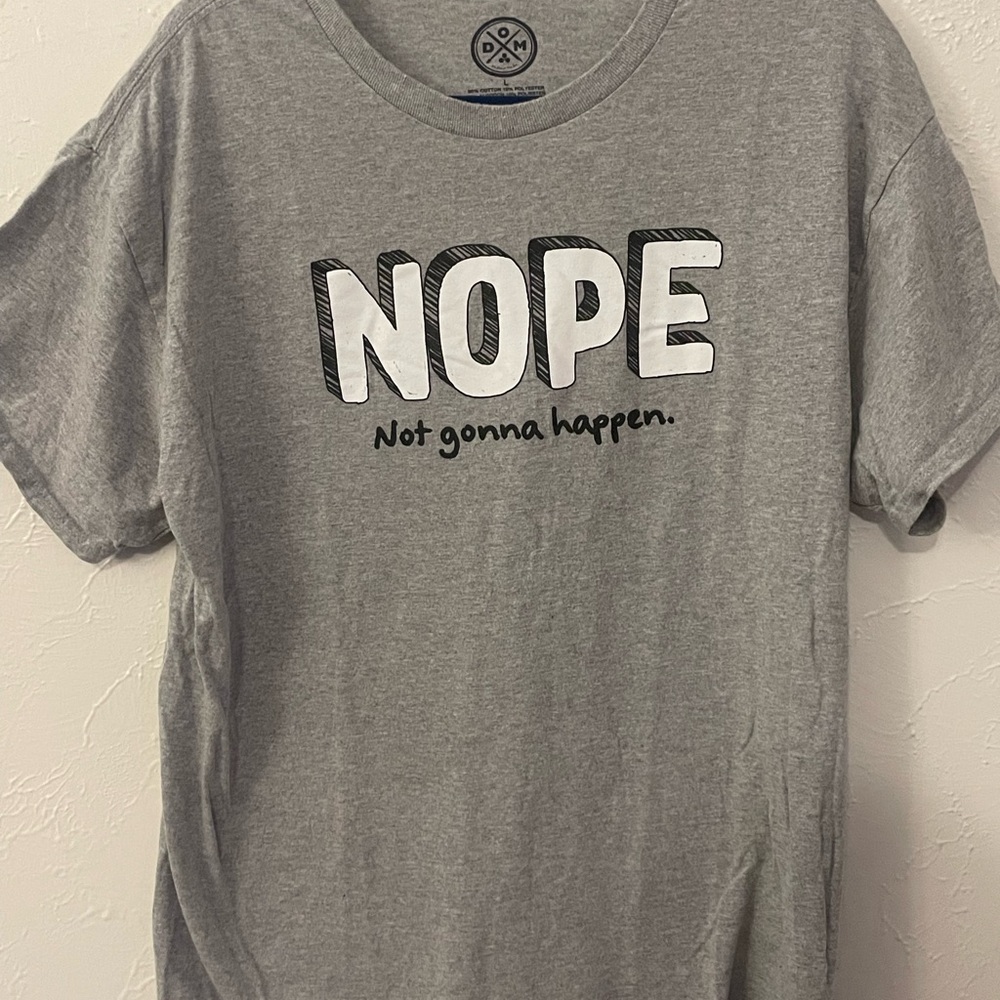 DOM brand graphic tee with the slogan “NOPE – Not gonna happen.”